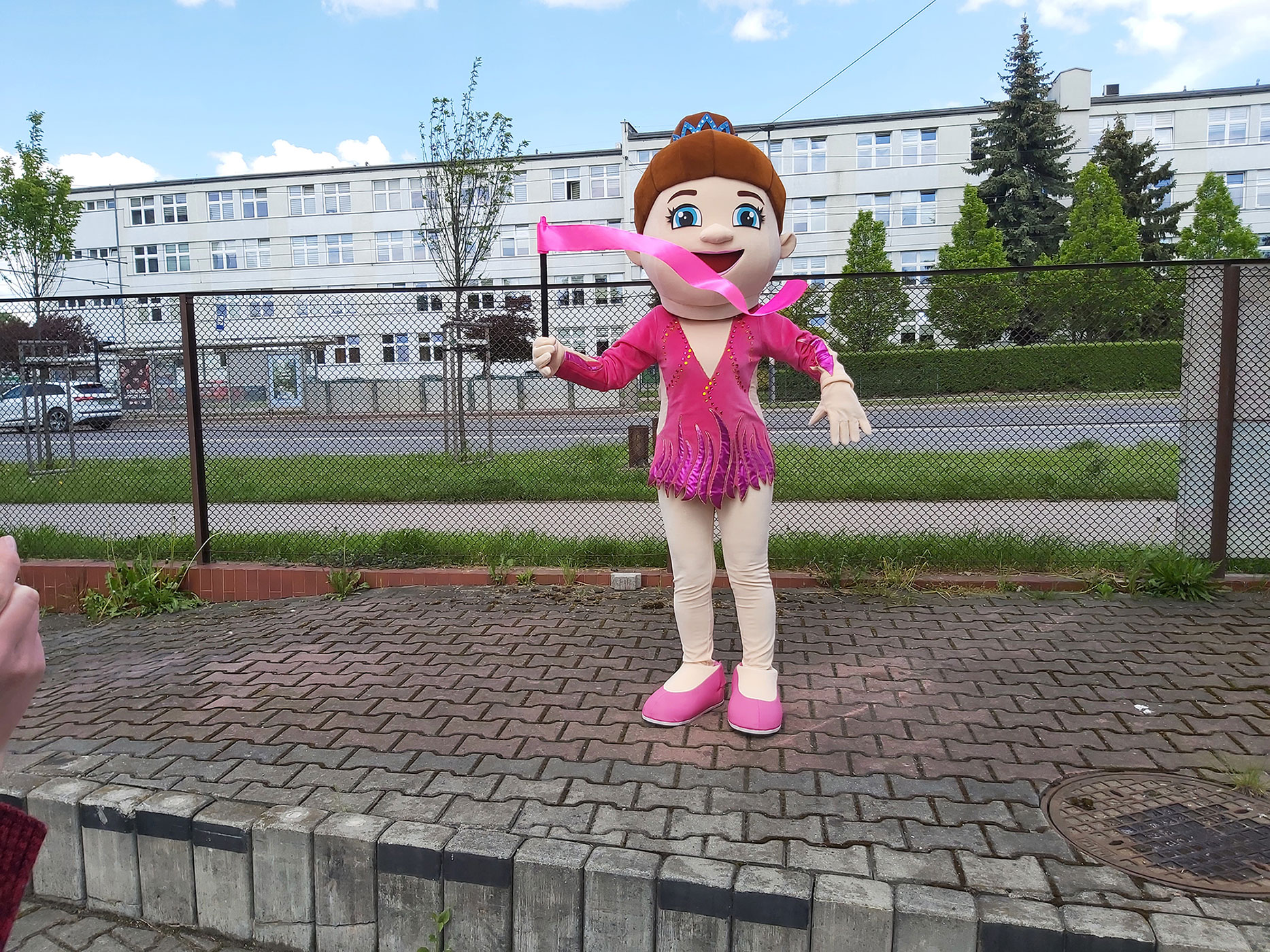 Do fotografii pozuje kostium dla hostessy w postaci gimnastyczki nieopodal siedziby firmy Elabika